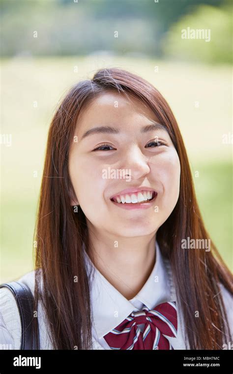 Cute Japanese High School Student In A City Park Stock Photo Alamy