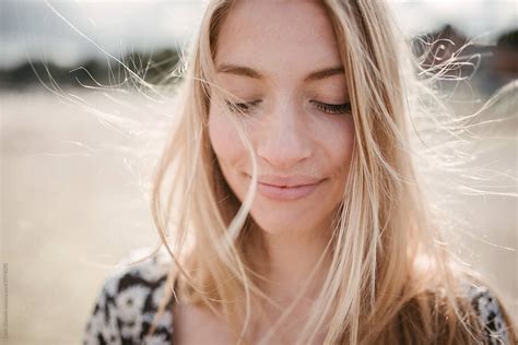 Smiling Woman With Blowing In Wind Hair By Chris Zielecki