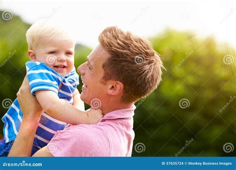 Father Hugging Young Son In Garden Stock Photo Image Of Playing Home
