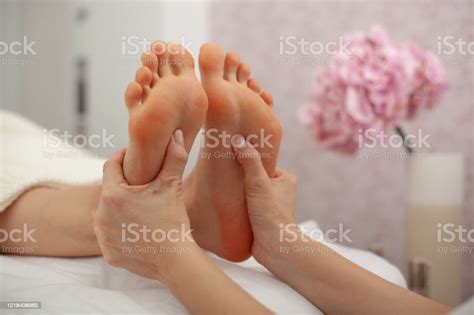 Cropped View Of Masseur Doing Foot Massage To Adult Woman In Beauty