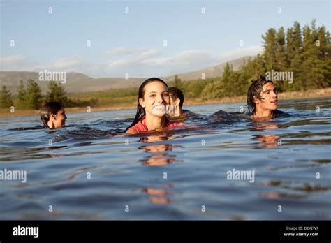 Smiling Friends Swimming In Lake Stock Photo Alamy