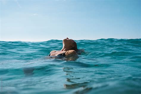 Young Woman Relaxing In The Sea By Stocksy Contributor Simone Wave Stocksy