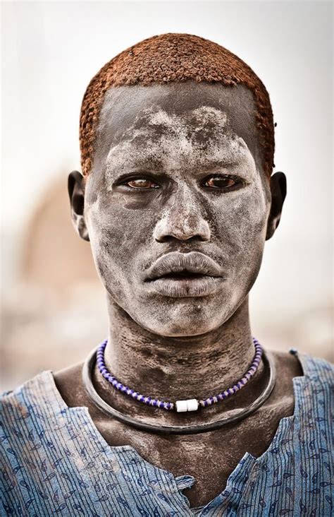 A Mundari Male Covered In Ash And Orange Hair Bleached In The Sun From