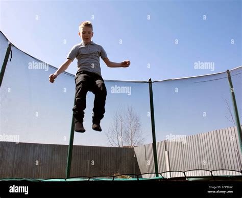 Boy Jumping On A Trampoline Jumping On A Trampoline Stock Photo Alamy