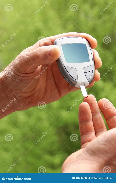 Close Up Of Man Hands Checking Blood Sugar Level By Glucose Meter For