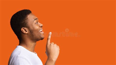 Excited Black Guy Having Idea Pointing Finger Up Orange Background