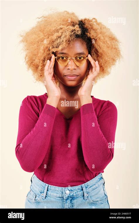 Woman With Afro Hairstyle Wearing Sunglasses While Looking Seriously At