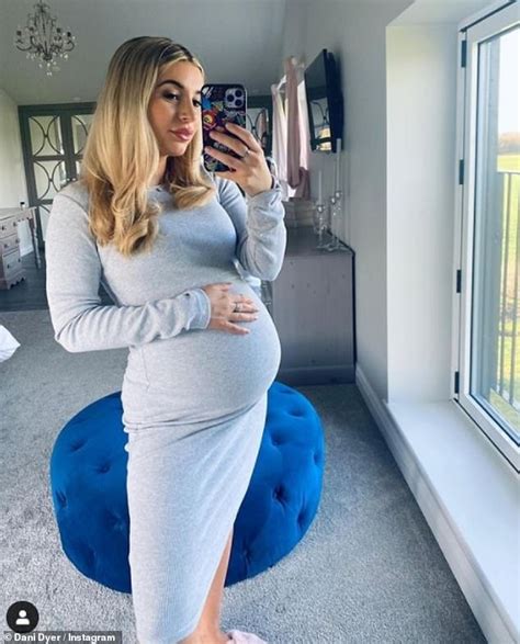 Pregnant Dani Dyer Gently Cradles Her Blossoming Baby Bump In A Grey