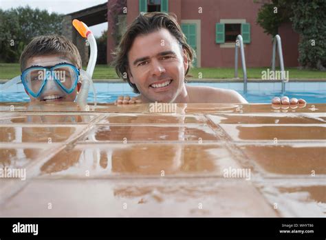 Portrait Of A Smiling Father With Son In Snorkeling Mask At Swimming