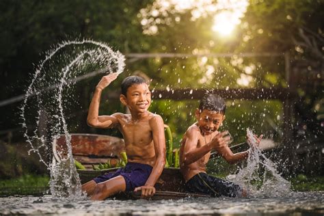 I spent the days with one of my closest friends. children play in the rain by Prasert Krainukul - Voubs.com