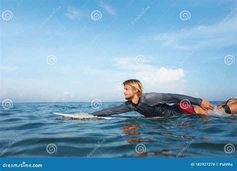 Surfing Handsome Surfer On Surfboard Portrait Guy In Wetsuit