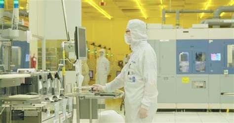 Workers In Clean Room In A Semiconductors Manufacturing Facility Stock