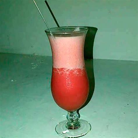 a drink in a glass with a straw sticking out of it