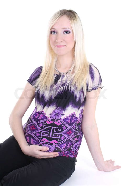 junge schwangere frau sitzt und hält ihren bauch auf weißem stock bild colourbox