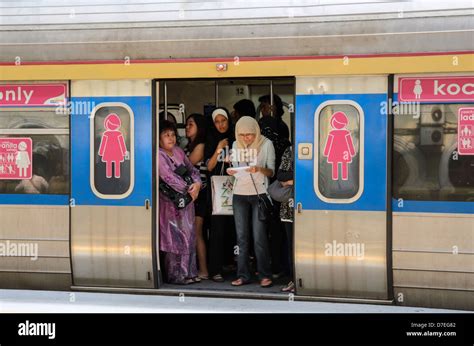 Women only carriage on a local city commuter train; woman only carriage; standing room only 