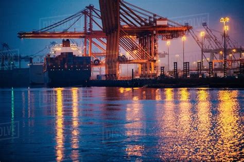 View Of Cargo Ship And Gantry Cranes In Harbor At Night Tacoma