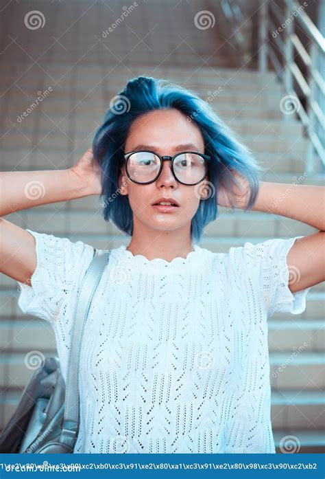 Close Up Portrait Of A Hipster Girl Wearing Glasses With Blue Hair