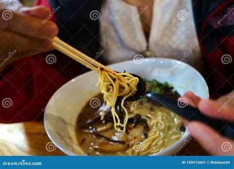 Chopsticks And Spoons In Action On Ramen Soup Stock Image Image Of