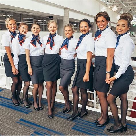 A Group Of Women In Uniforms Standing Next To Each Other On A Ship Or Plane