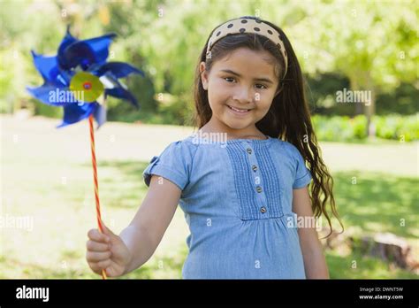 Cute Little Girl Holding Pinwheel At Park Stock Photo Alamy