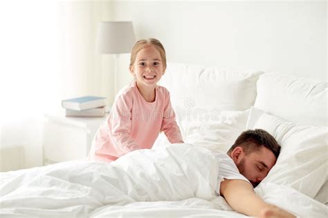 Little Girl Waking Her Sleeping Father Up In Bed Stock Image Image Of