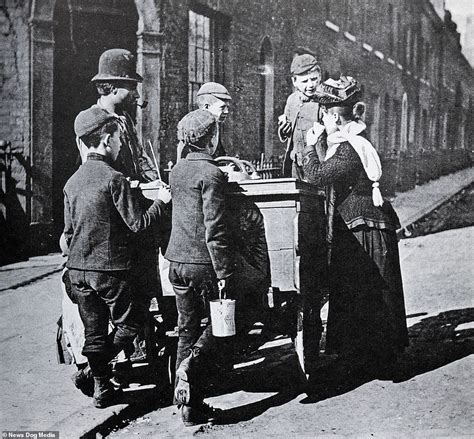 A Group Of Children Speak To A Man And Woman At An Ice Cream Vendors
