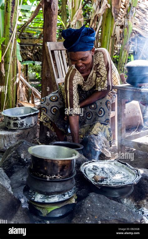 A Woman Cooking A Traditional African Meal Of Potato Meat And