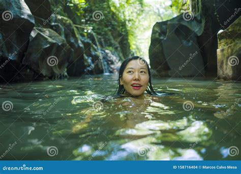 Happy Asian Chinese Woman In Bikini Enjoying Unique Summer Holidays At Tropical Forest
