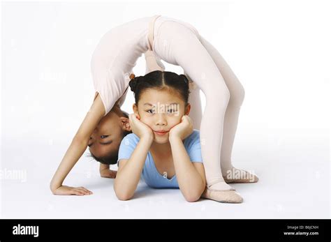 One Girl Bend Down Her Body Over The Other Girl Stock Photo Alamy