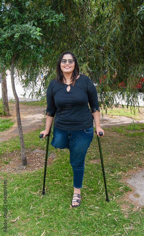 Young Beautiful Amputee Woman Walking With Crutches Stock Foto Adobe