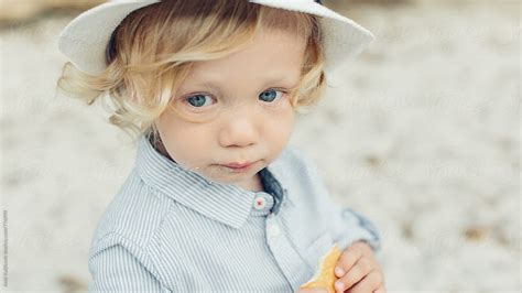 Cute Little Blond Boy With A Solemn Expression By Stocksy Contributor