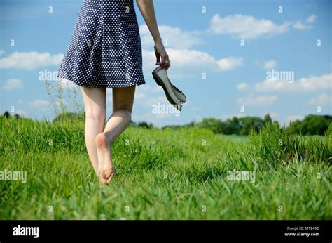 Female Walks On The Grass With Barefoot Young Woman Enjoys Outdoor Walk Nature Green Fields