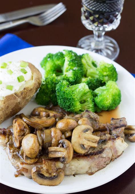 A White Plate Topped With Meat Mushrooms And Broccoli Next To A Piece