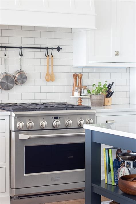 Amazing gallery of interior design and decorating ideas of white kitchen with navy island in kitchens by elite interior designers. Navy Island White Kitchen - The Lilypad Cottage
