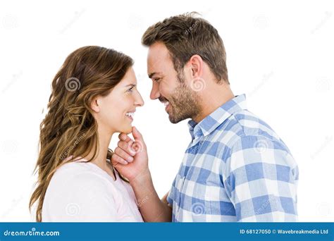 Happy Young Couple Looking At Each Other And Smiling Stock Photo