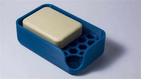 A White And Blue Object Sitting On Top Of A Table Next To A Gray Surface