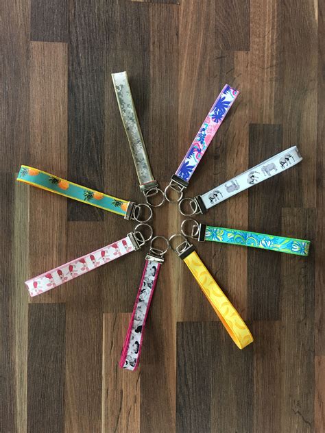 A Bunch Of Different Colored Key Chains On A Wooden Floor With The Word