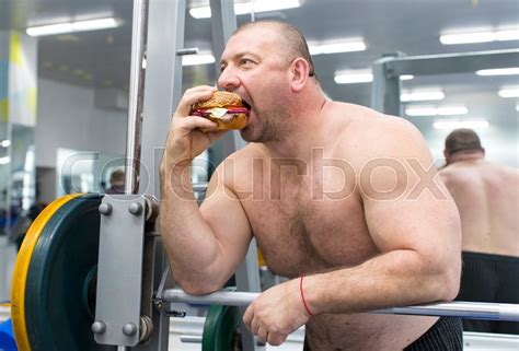A Big Fat Hungry Man Eats A Hamburger Stock Image Colourbox