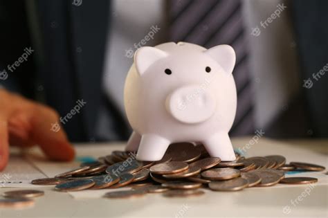 Premium Photo Hand Businessman Putting Pin Money Into Pig