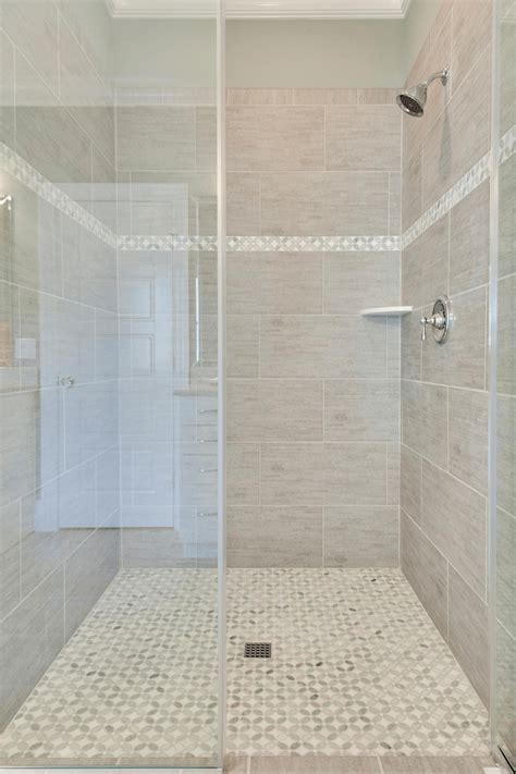 Glazed porcelain tile is excellent for shower walls. Large Grey Tiles with White Accent | Gray shower tile, Bathrooms remodel, Shower remodel