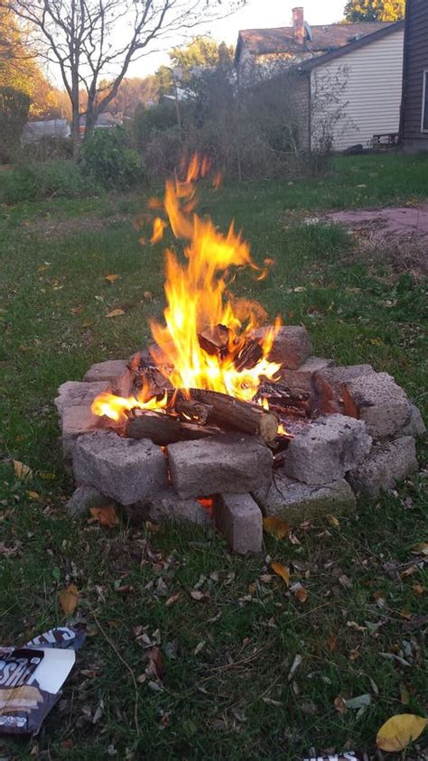 Bonfire In Backyard Between Rocks And Grass In Night Stock Photo