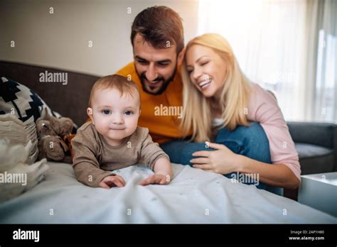 Happy Parents Changing Diaper To Their Baby Boy Stock Photo Alamy