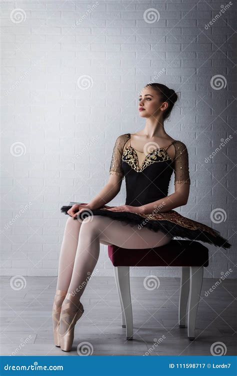 Portrait Of Young Beautiful Perfect Ballerina Sitting On Chair Indoors
