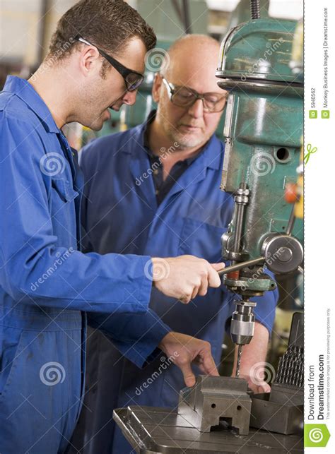 Two Machinists Working on Machine Stock Photo - Image of machinery ...