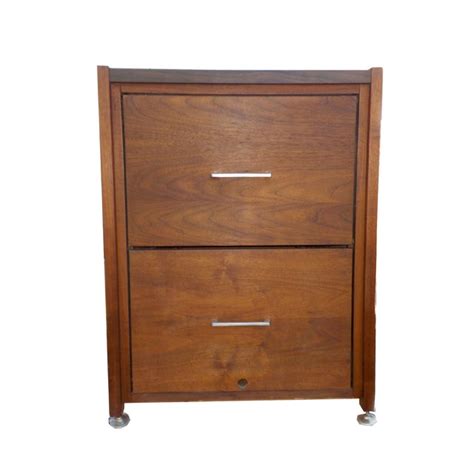 Select a filing cabinet with features like locking drawers for increased security or casters for mobility. Mid Century Modern Minimalist Wood Filing Cabinet | Chairish