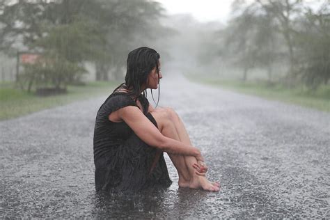 Woman Sitting Enjoying The Rain By Stocksy Contributor Yasir Nisar Stocksy