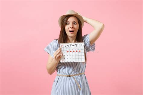 Portrait Of Shocked Woman In Blue Dress Hat Holding Periods Calendar