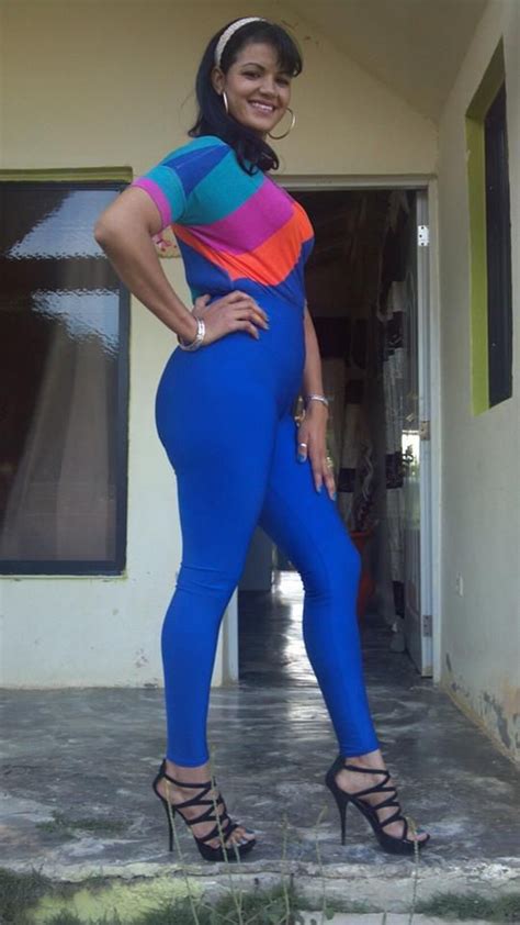 Gorgeous And Tall Latina Brunette Girl In In Blue Jumper Suit And Heels Hair Band