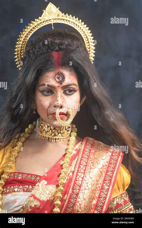 portrait of beautiful indian girl of durga idol agomoni concept indoor photo wearing traditional
