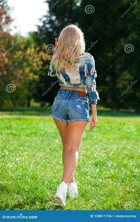 Beautiful Blonde Woman Dressed In A Denim Jacket And Shorts Stock Photo Image Of Hair Model